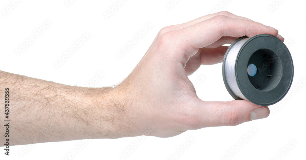 Line reel accessories in hand on white background isolation