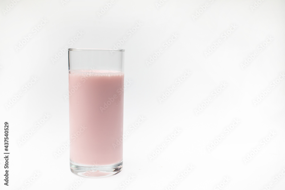 A glass of strawberry milk on isolated white background. A glass of strawberry milk on isolated white background.