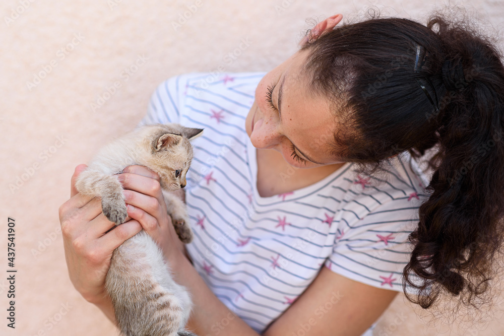 Girl holding a new baby kitten. Happy child holds a cat in her arms. Girl holding a new baby kitten. Happy child holds a cat in her arms.