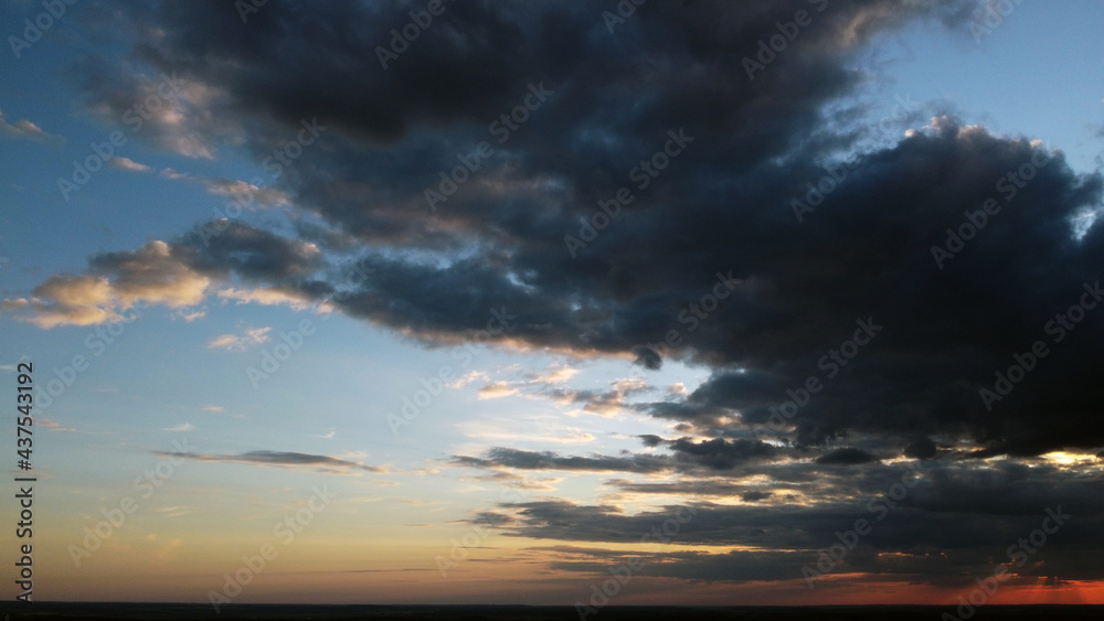 Beautiful contrasting clouds in the sky at sunset. Background for design Beautiful contrasting clouds in the sky at sunset. Background for design