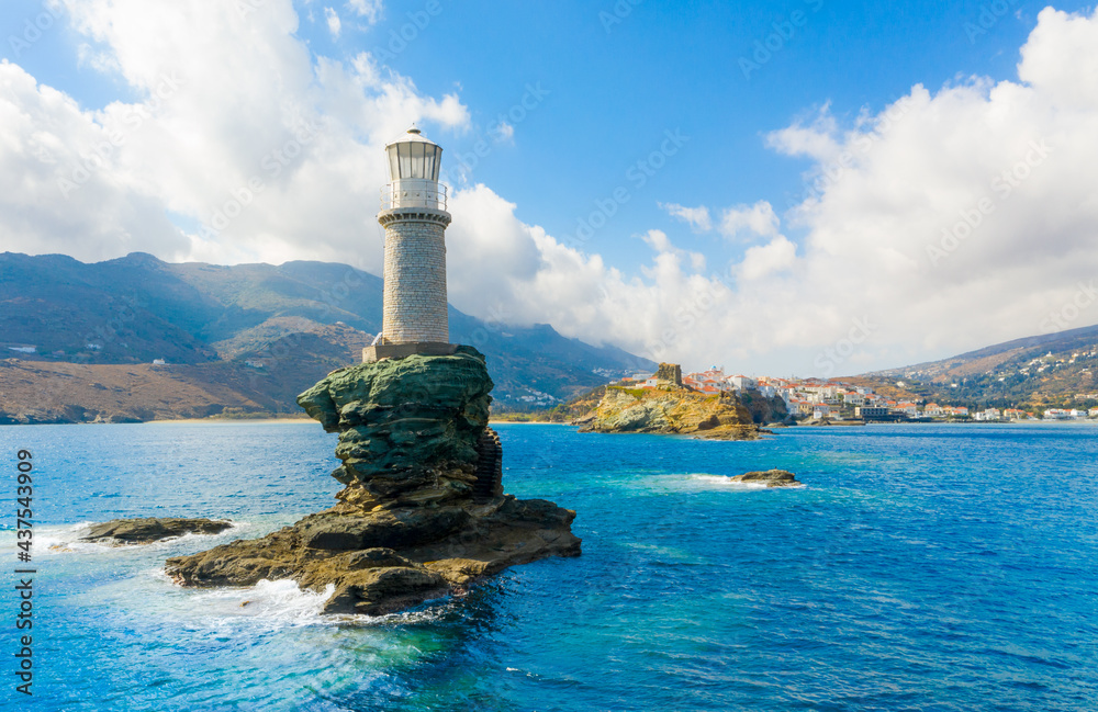 The beautiful Lighthouse Tourlitis of Chora at night. Andros island, Cyclades, Greece