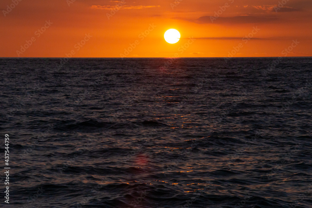 sunset in the middle of the sea