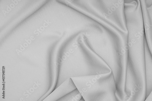 Gray cloth, silk, fabric surface with soft waves of gray fabric texture background.