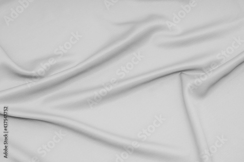 Gray cloth, silk, fabric surface with soft waves of gray fabric texture background.