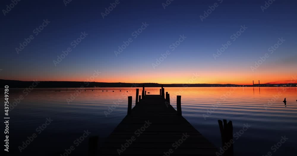 Old dock and dramatic sunset over the sea lake Old dock and dramatic sunset over the sea lake