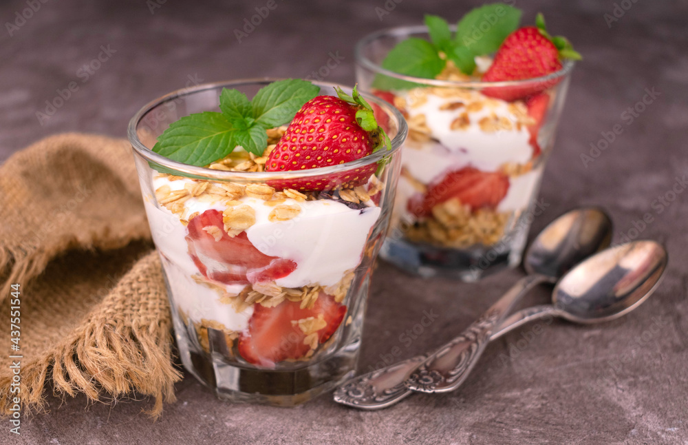 Healthy breakfast of strawberry granola and yogurt on a gray background. Healthy breakfast of strawberry granola and yogurt on a gray background.