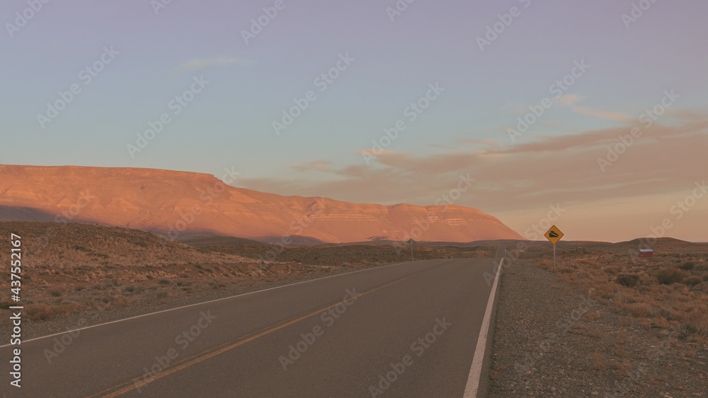 Sunset in the Mountains. El Chalten Road, Patagonia, Argentina. Mountains Bathed in the Evening Sun. Orange Mountains on a Biue Sky Background. 