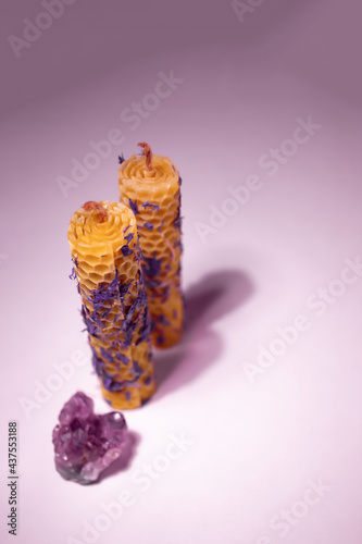 Pair of beeswax eco-candles with cornflowers and gemstone. Ethnic style. Vertical photo. There is a space for text.