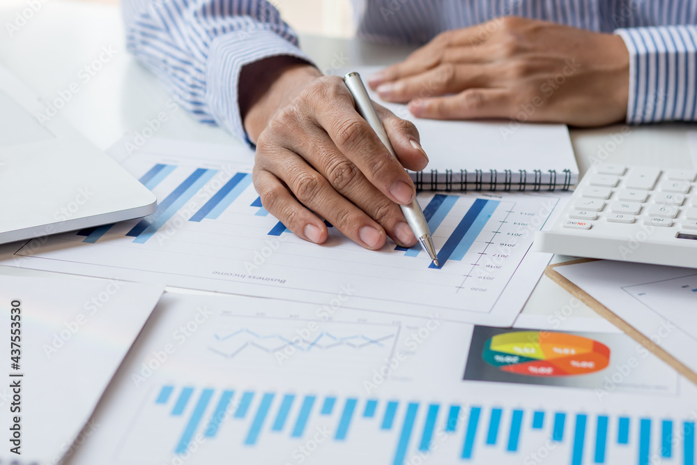 Financial Business man analyze the graph of the company's performance to create profits and growth, Market research reports and income statistics, Financial and Accounting concept. Financial Business man analyze the graph of the company's performance to create profits and growth, Market research reports and income statistics, Financial and Accounting concept.