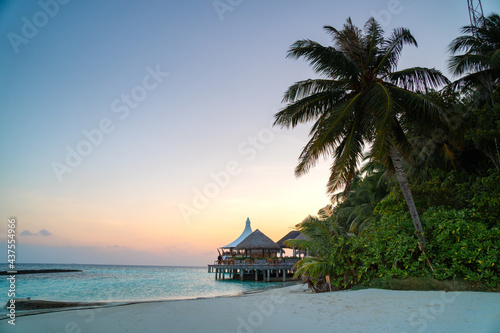Amazing tropical Maldives island panorama. Beautiful beach and lagoon landscape background during sunrise. Vacation, holiday and romantic honeymoon banner concept.