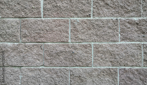 A wall of gray blocks. Background from large bricks