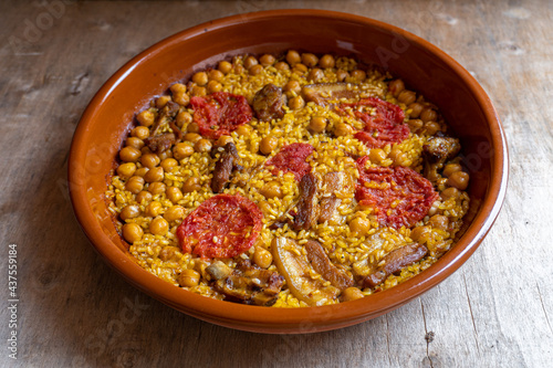 "Rice in the oven" Typical Spanish dish from the Valencian region, based on rice and meat, with tomato chickpeas and sometimes sausage as black pudding. Cooked in a clay pot.