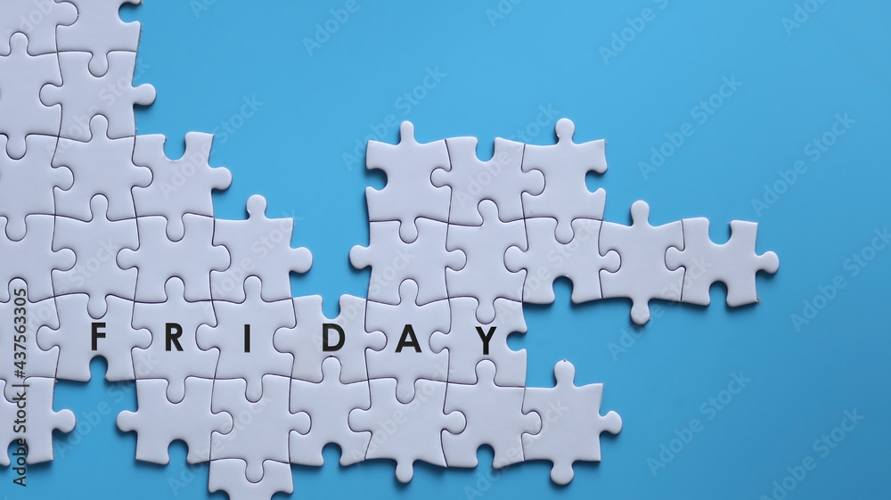 FRIDAY word written on white jigsaw puzzle