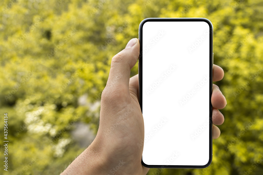 man’s hand holding and showing smartphone with blank white screen, Mockup image. Modern phone with blank screen.