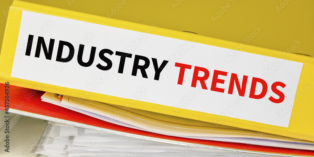 INDUSTRY TRENDS text on binders stacked over. Business concept. INDUSTRY TRENDS text on binders stacked over. Business concept.