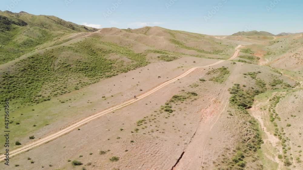 Drone shot of bicyclist ride in the mountains of Kazakhstan