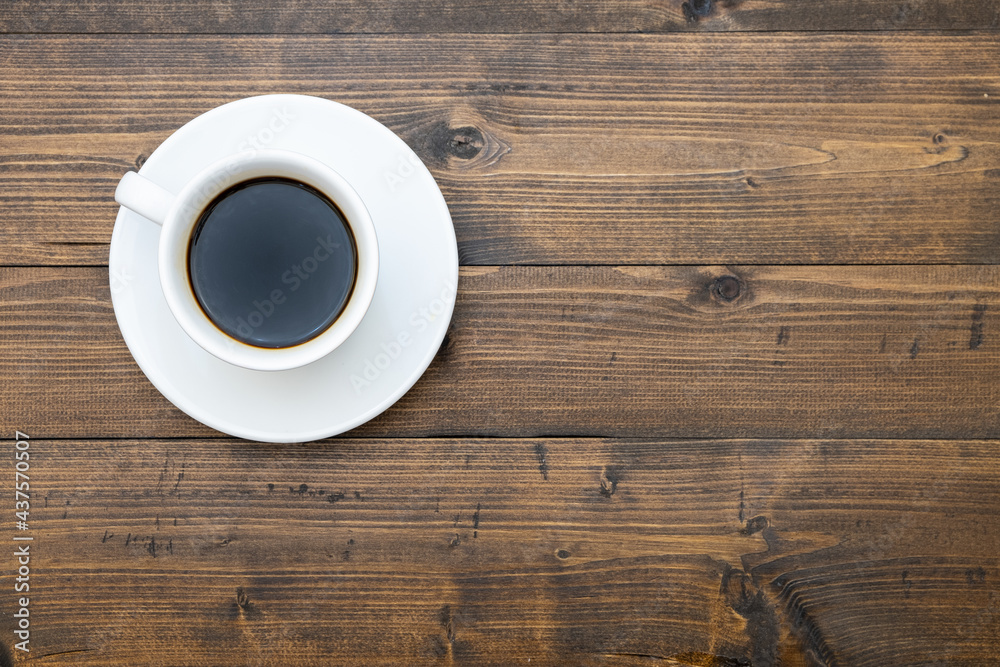 Top view of white coffee cup on wooden background Top view of white coffee cup on wooden background