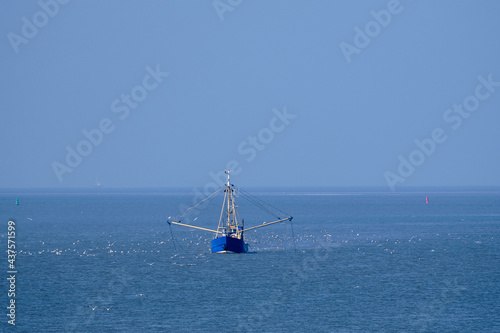 Ameland, Netherlands-April,19,2021: Fishing boat, nets and seagulls on the Wadden Sea. Fisherman conflict escalates: British, French and Dutch arguing over North Sea and electric pulse fishing
