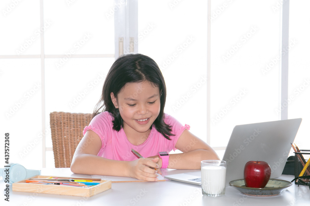 Adorable Asian girl happy learning online with technology laptop on desk at home, school girl typing answer or response with teacher study homeschool or learn from home, smart kids with technology Adorable Asian girl happy learning online with technology laptop on desk at home, school girl typing answer or response with teacher study homeschool or learn from home, smart kids with technology