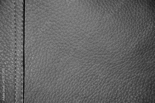 Gray leather background. Textured design with lines, double stitch on left side and seam. Stylish silver textile fabric for elegant empty backdrop with copy space, luxury concept, fashion ad, etc.