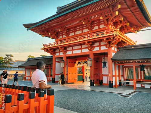 Photography Black Man Admiring a Red Shrine & Temple in Kyoto, Japan at Sunset (Tourism in F
