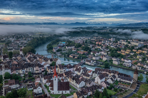 aerial view of a medieval town and the alps 