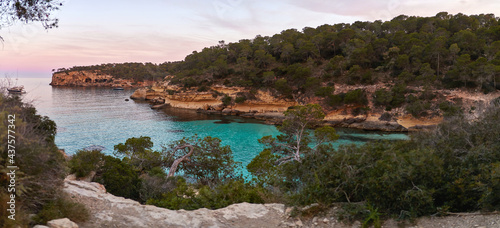 Panorama of El Mago cove with turquoise waters during sunset in Mallorca, Spain.