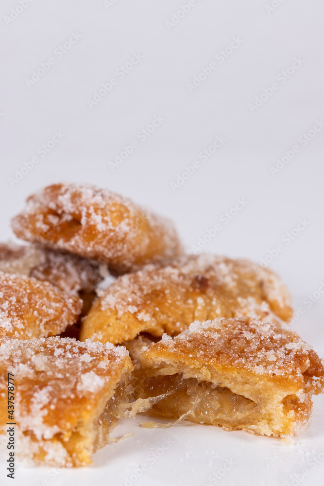 Fried sweet (borrachuelo) stuffed with angel hair, a typical Spanish dessert from Andalusia. Ideal for Christmas and Easter. Vertical shot and selective focus.