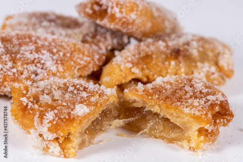 Fried sweet (borrachuelo) stuffed with angel hair, a typical Spanish dessert from Andalusia. Ideal for Christmas and Easter. Horizontal shot and selective focus.