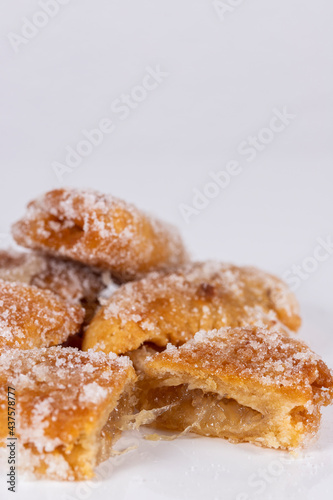 Fried sweet (borrachuelo) stuffed with angel hair, a typical Spanish dessert from Andalusia. Ideal for Christmas and Easter. Vertical shot and selective focus.