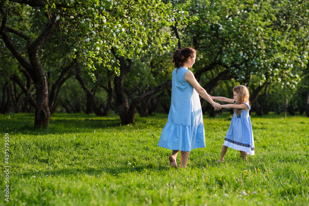 nature scene with family outdoor lifestyle. Mother and little daughter playing together in a park. Happy family concept. Happiness and harmony in family life. nature scene with family outdoor lifestyle. Mother and little daughter playing together in a park. Happy family concept. Happiness and harmony in family life.
