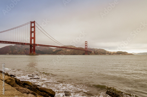 Golden Gate Bridge in San Francisco on a windy day and the wavy ocean