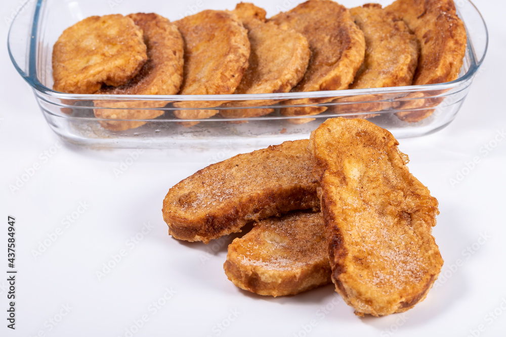 Fried bread with milk, egg, sugar and cinnamon (Torrijas). Typical Spanish Easter sweet. Horizontal photography and selective focus Fried bread with milk, egg, sugar and cinnamon (Torrijas). Typical Spanish Easter sweet. Horizontal photography and selective focus