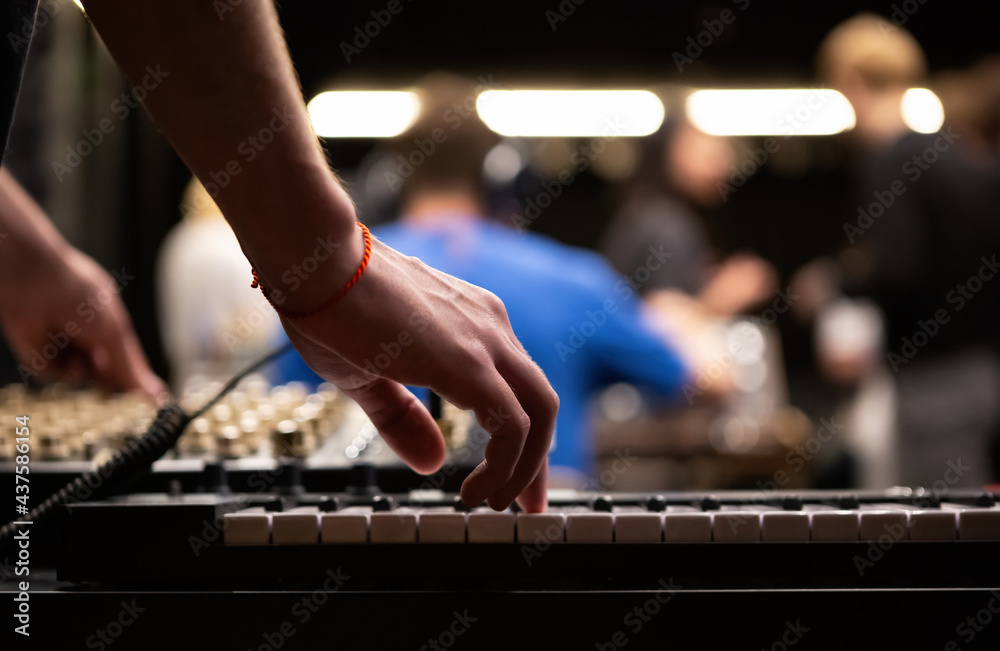 Musician playing on midi synthesizer piano in sound recording studio