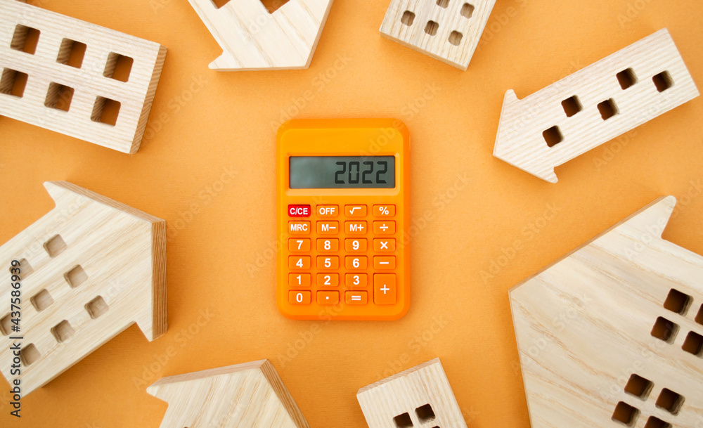 Family budget planning. Investments, plans, savings. Mortgage and mortgage rates. Real estate concept. Forecasts. Loan. Refinance home. Wooden houses and calculator 2022. Family budget planning. Investments, plans, savings. Mortgage and mortgage rates. Real estate concept. Forecasts. Loan. Refinance home. Wooden houses and calculator 2022.