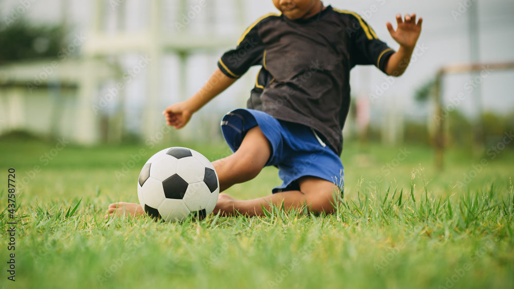 Obraz premium Action sport outdoors of kids having fun playing soccer football for exercise at the green grass field.