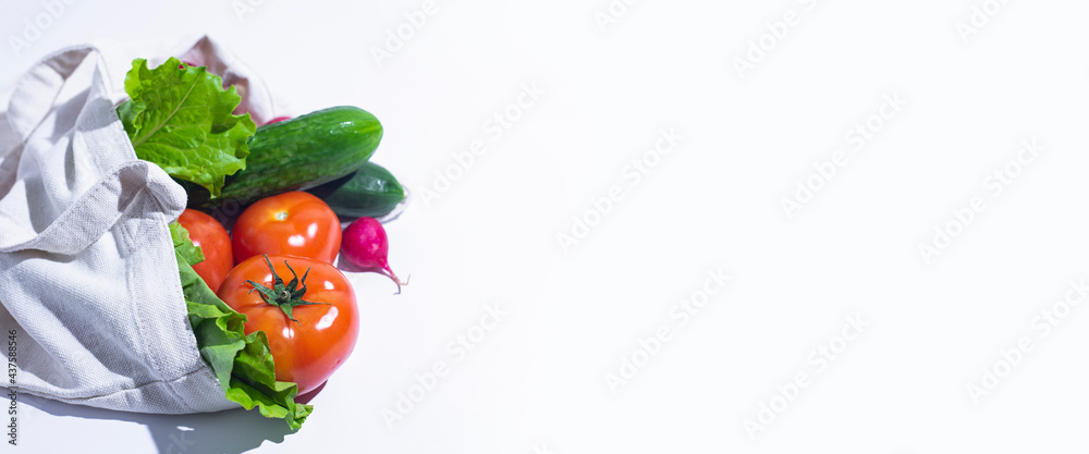 fresh vegetables, lettuce leaves in a shopping bag on a white background. Top view, flat lay. Banner fresh vegetables, lettuce leaves in a shopping bag on a white background. Top view, flat lay. Banner