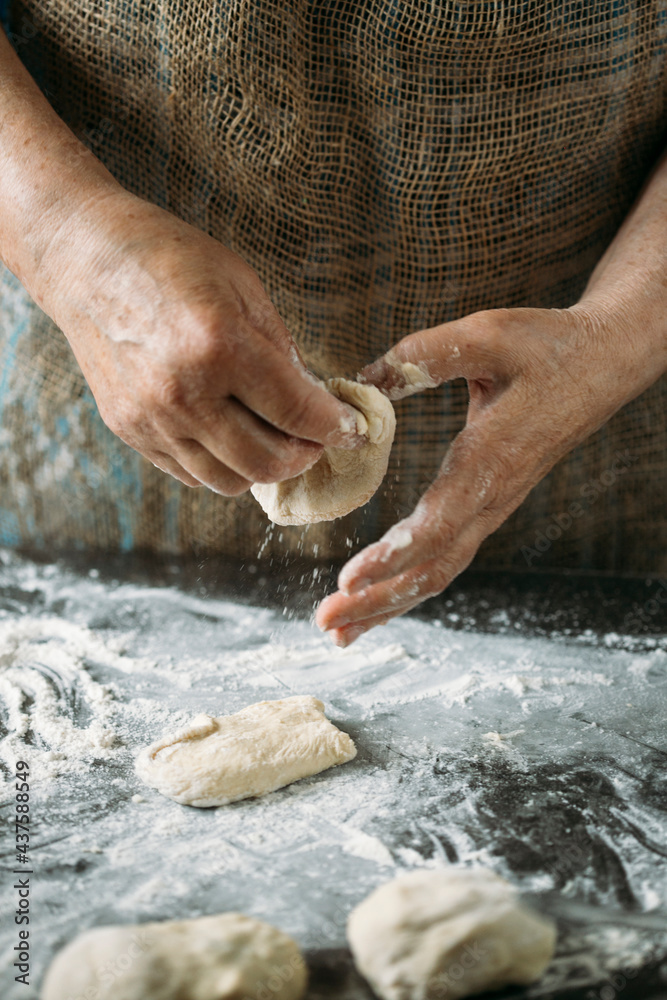 close-up view of hands making delicious pies with dough