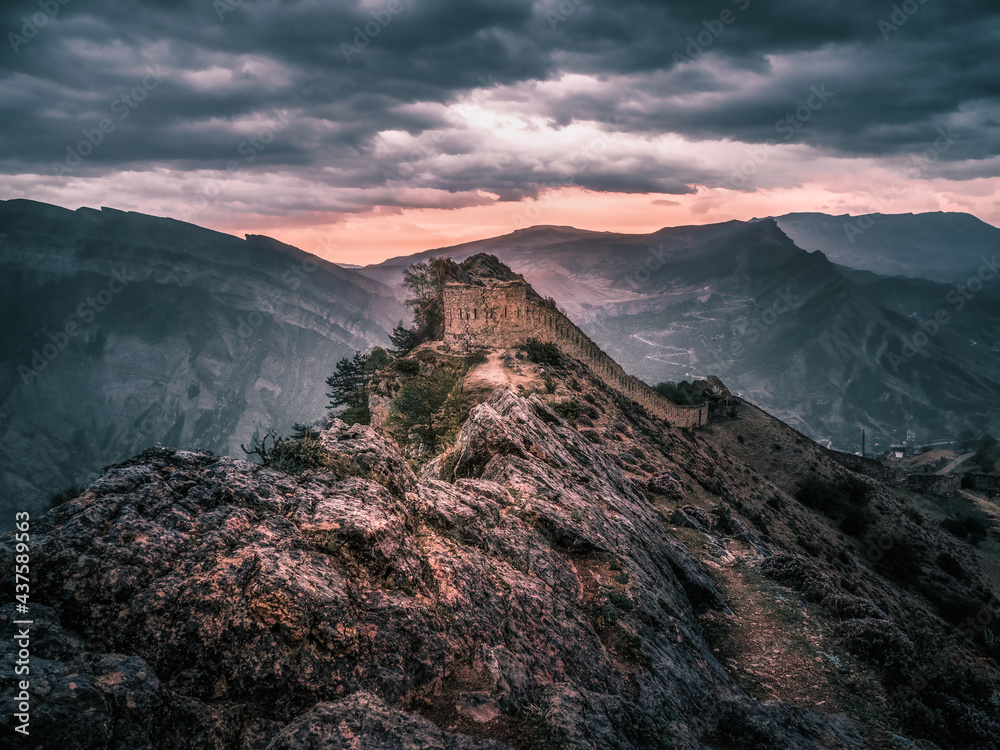 Dramatic view at the ancient fortress on the top of the mountain. The Gunib fortress is a historical monument of Dagestan. Russia.