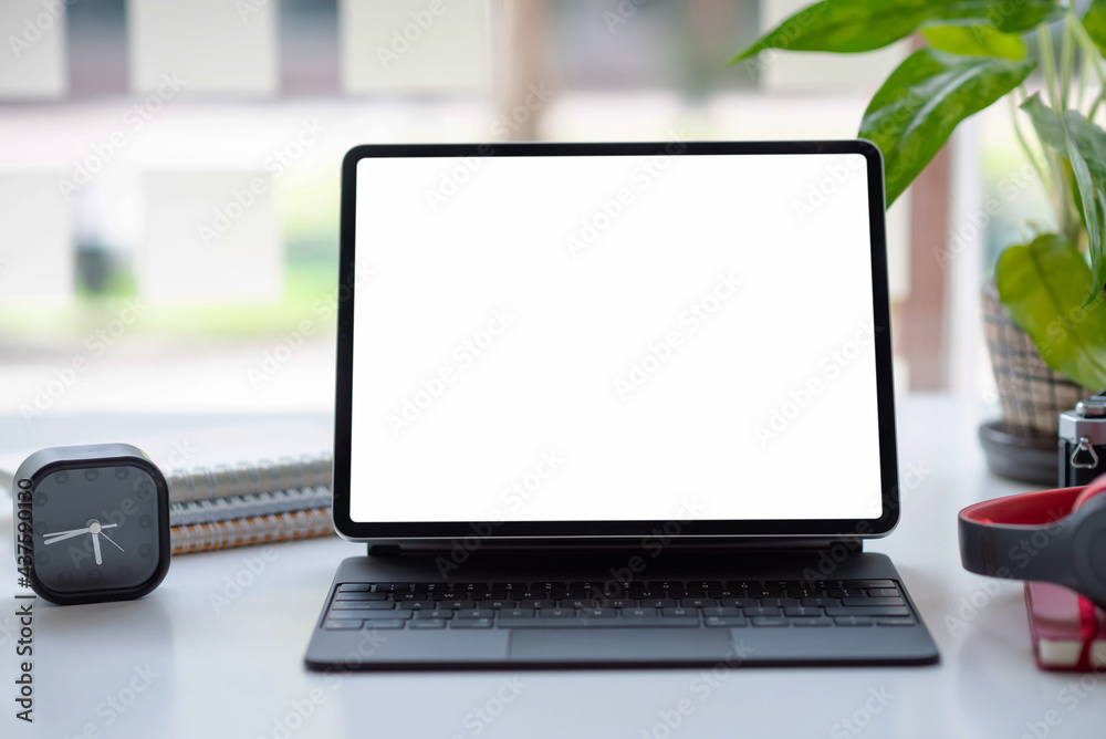 Fototapeta premium Office desk with laptop blank white screen with notebook coffee mugs. Mock up.