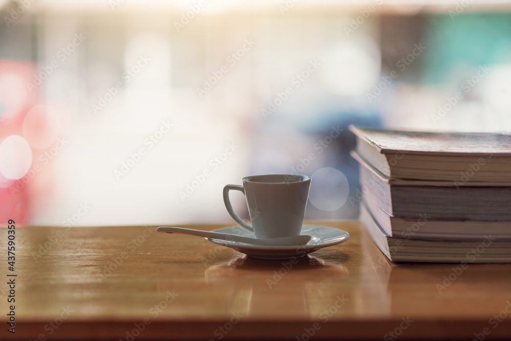 Hot coffee mug and notebook on wooden table with blurred back. Hot coffee mug and notebook on wooden table with blurred back.