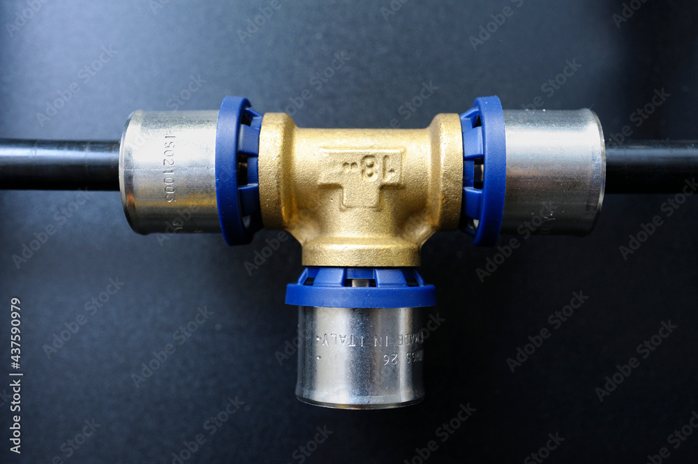 Multipurpose press fitting for multilayer pipes placed on a stand. Plumbing equipment Multipurpose press fitting for multilayer pipes placed on a stand. Plumbing equipment