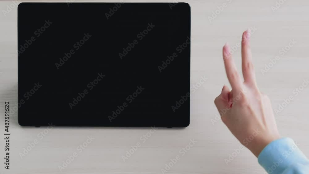 Online meeting. Victory sign. Web conference. Quarantine measures. Unrecognizable woman showing greeting peace gesture portable computer blank screen light table copy space. Online meeting. Victory sign. Web conference. Quarantine measures. Unrecognizable woman showing greeting peace gesture portable computer blank screen light table copy space.