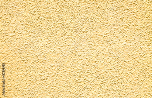 Yellow beton textured wall background and wallpaper copy space