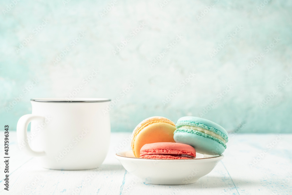 colorful macaroons and coffee on wooden table with copy space colorful macaroons and coffee on wooden table with copy space