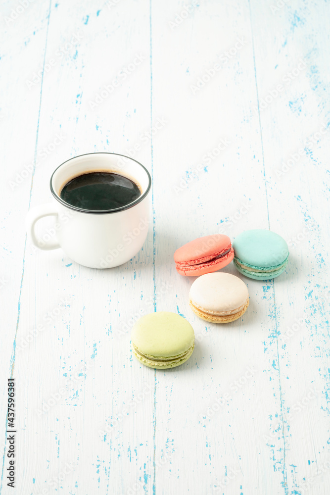 colorful macaroons and coffee on wooden table with copy space colorful macaroons and coffee on wooden table with copy space