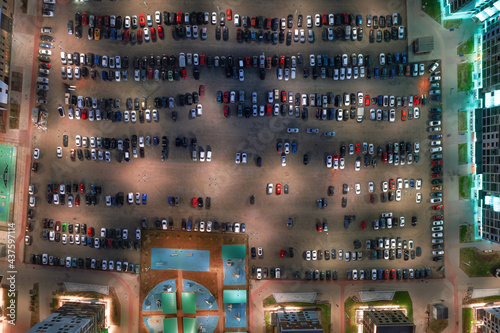 Parking lot full of cars aerial top view at night