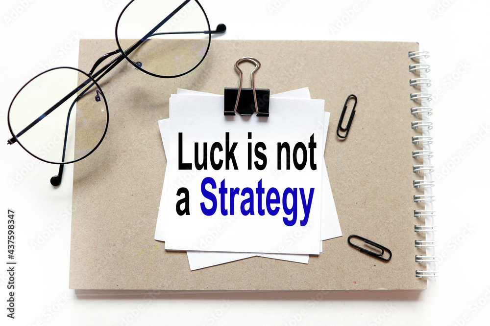 Luck is not a Strategy. stickers on notepad, text on white sticker on white background Luck is not a Strategy. stickers on notepad, text on white sticker on white background