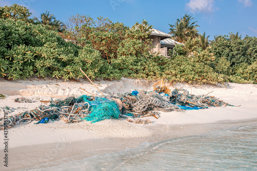Stranded fishing nets and garbage. The concept of ocean pollution-negative impact on the ecological situation on the planet photo