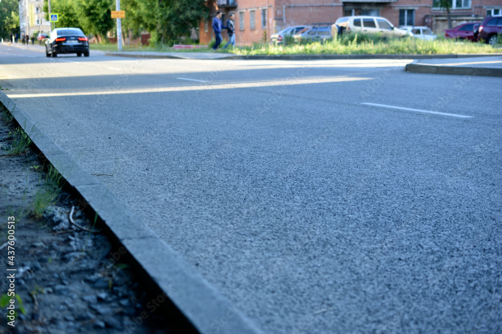 Asphalt surface and street in the city in summer